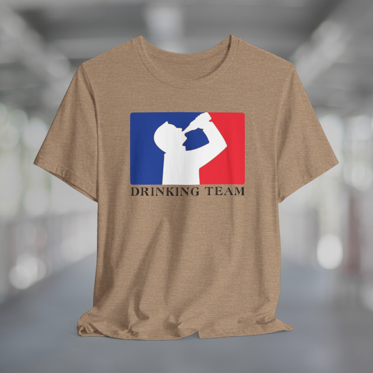 Heather tan t-shirt with white silhouette of man drinking beer with red and blue background, like professional sports logo, and words Drinking Team underneath