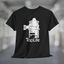 Black t-shirt with white graphic of Bigfoot holding a beer mug, sitting in a lawn chair with leg crossed in relaxed position, Tap Life logo below.