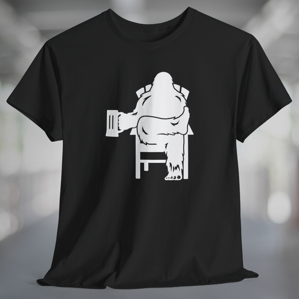 Black t-shirt with white graphic of Bigfoot relaxing in a chair and enjoying a mug of beer.