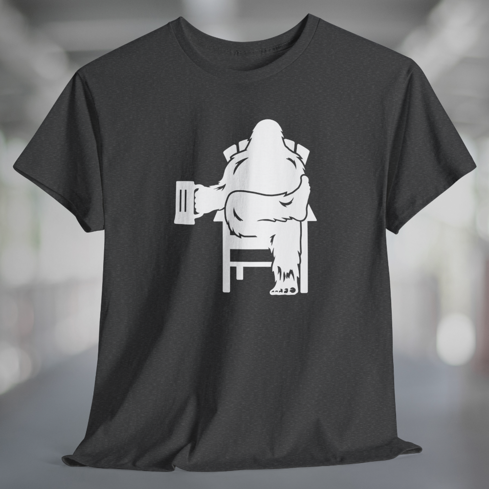 Heather charcoal gray t-shirt with white graphic of Bigfoot relaxing in a chair and enjoying a mug of beer.