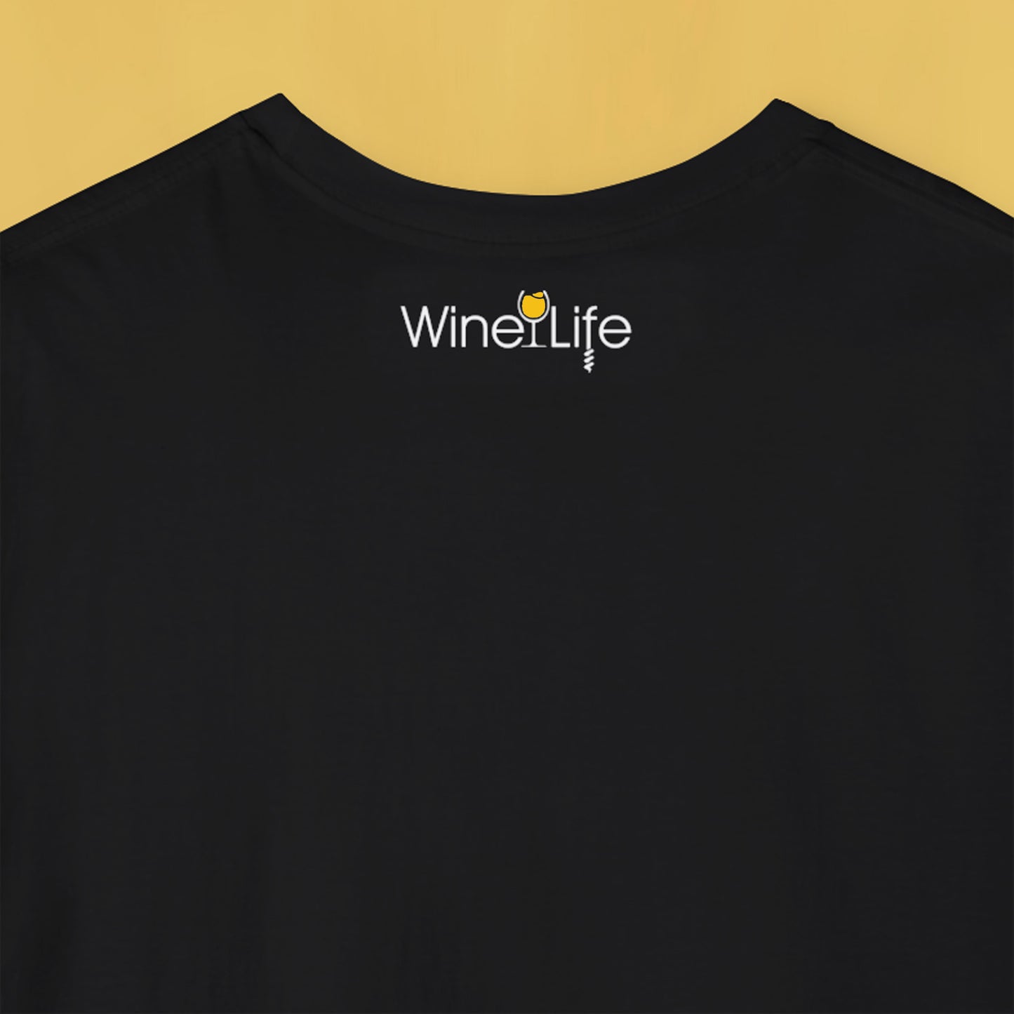 Back neckline of a black t-shirt with Wine Life logo featuring a yellow wine glass and corkscrew
