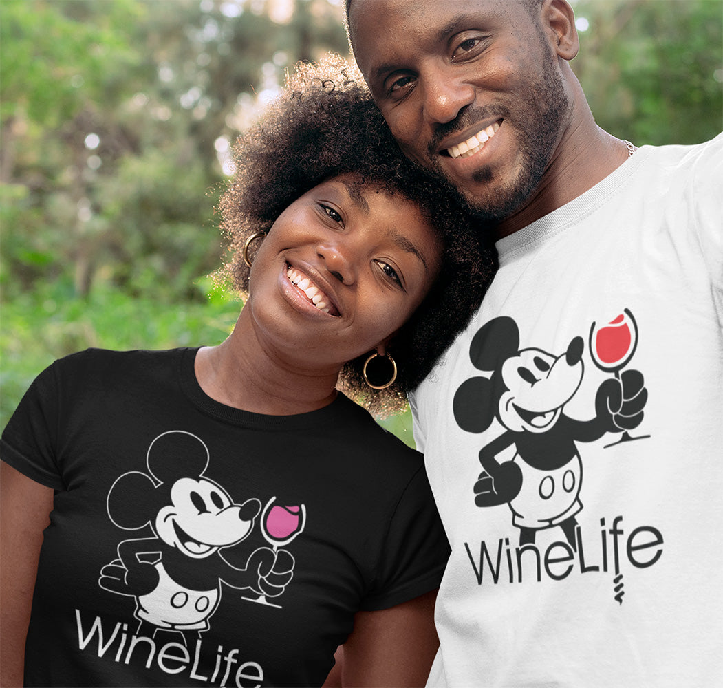 A cute couple wearing black and white shirts, with a mouse drinking a glass of red and rose wine
