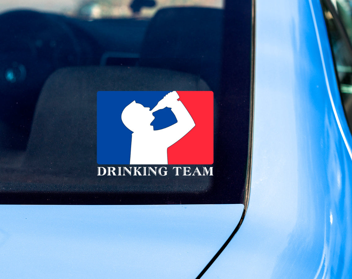 Back window of car with decal sticker of silhouette man drinking beer with red and blue background, like professional sports logo, and words Drinking Team underneath.