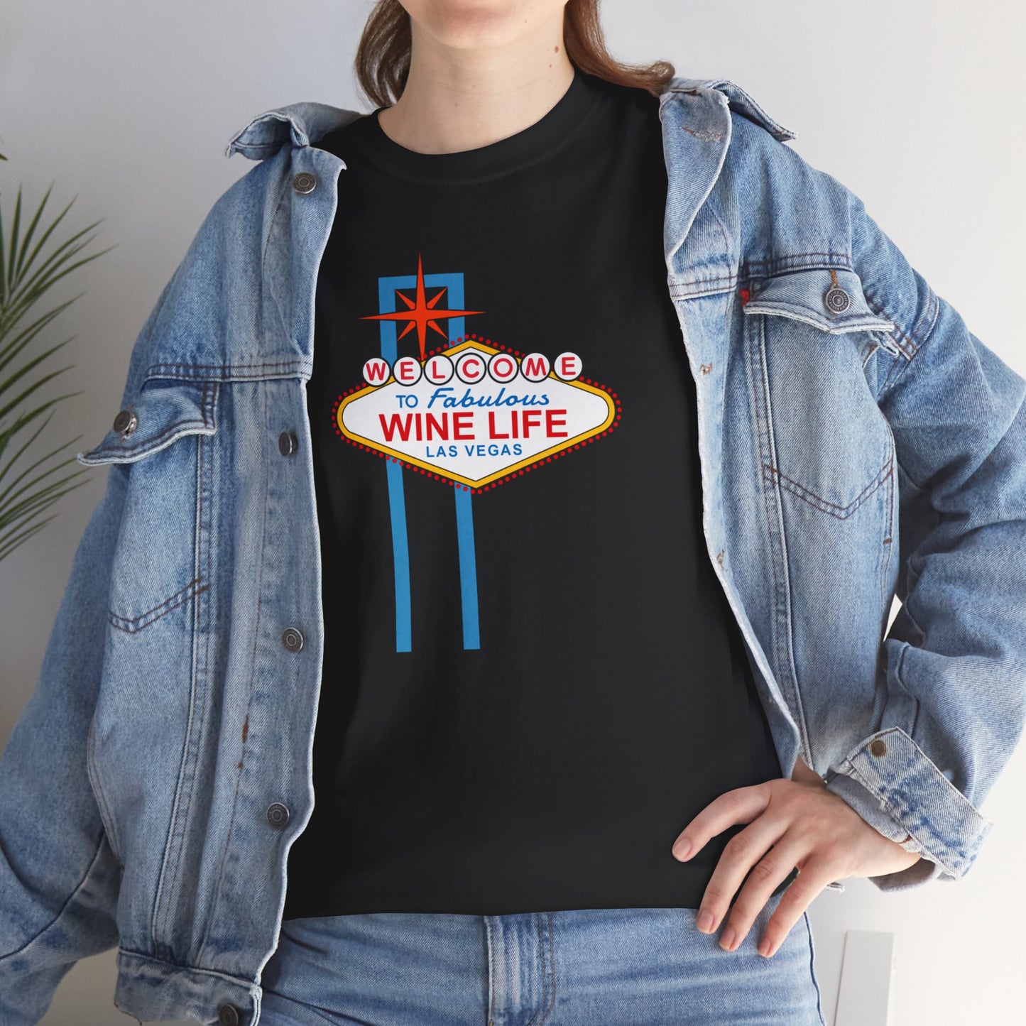 Woman wearing black t-shirt with Las Vegas sign that says Welcome to Fabulous Wine Life Las Vegas