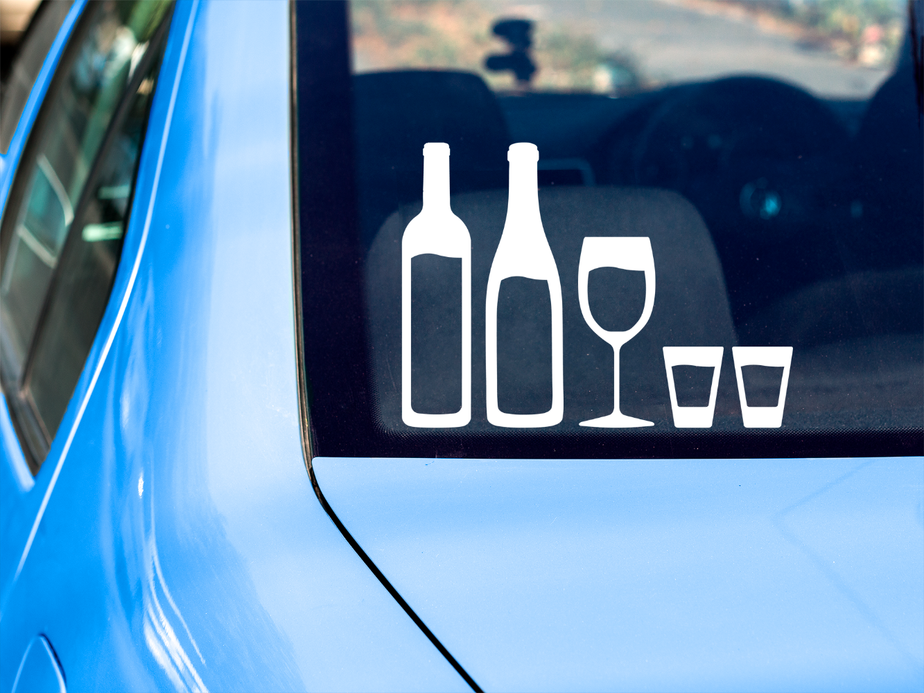 Car rear window with stick figure family decals of wine bottles, wine glass, and shot glasses
