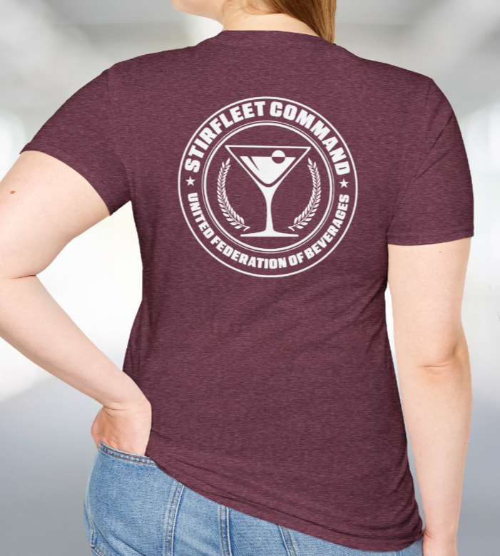 Woman wearing Heather red maroon t-shirt, with white United Federation of Beverages Stirfleet Command logo, martini glass graphic on back of shirt.