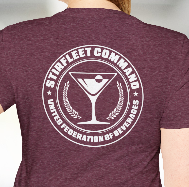 Woman wearing heatherred maroon t-shirt, with white United Federation of Beverages Stirfleet Command logo, martini glass graphic on back of shirt.