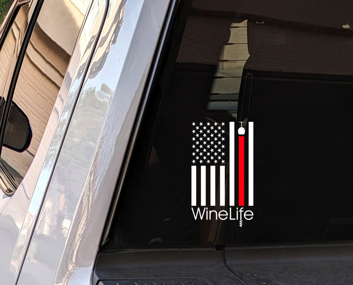 White decal of American flag with one red stripe pouring from a wine glass, Wine Life logo below