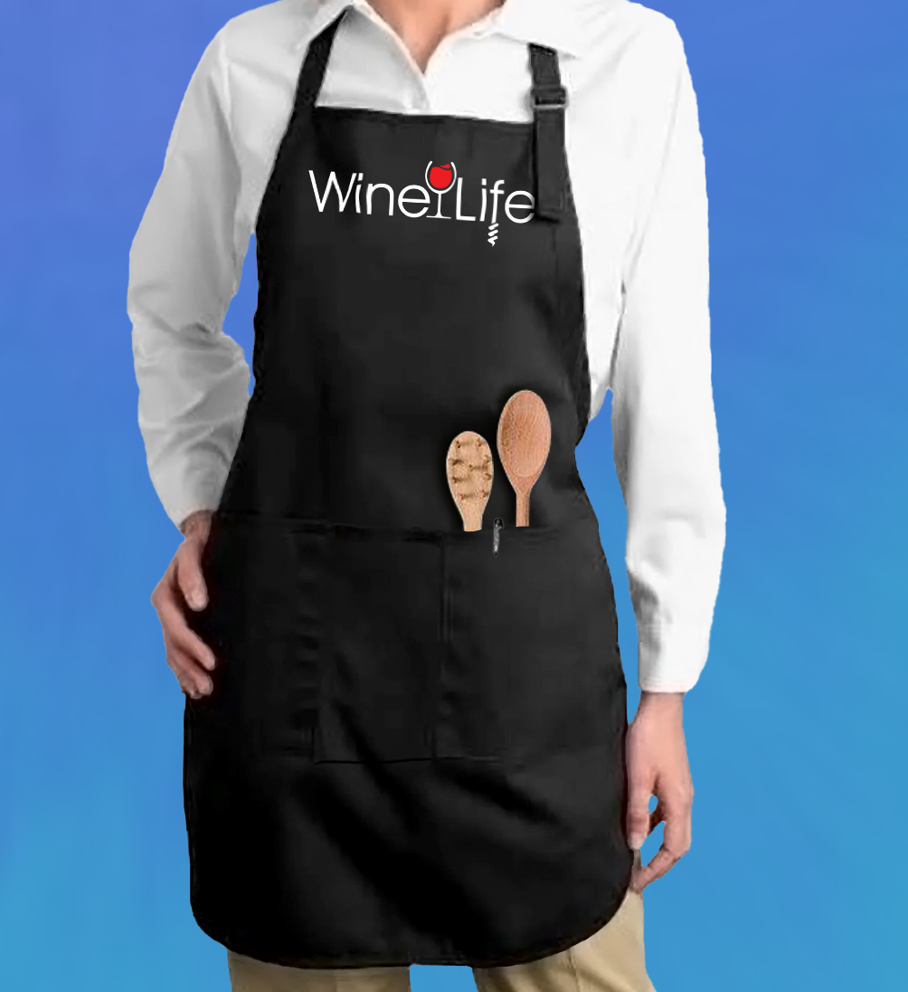 Woman wearing a black apron with a graphic print of the red Wine Life logo across the front.