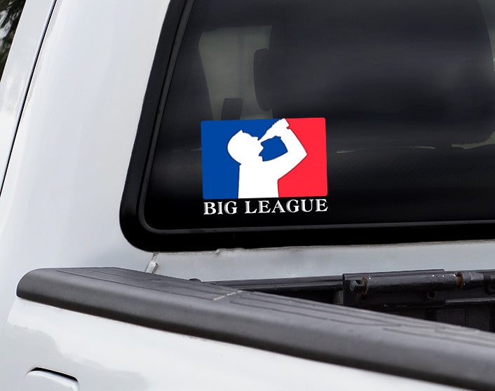 Back window of truck with decal sticker of silhouette man drinking beer with red and blue background, like professional sports logo, and words Big League underneath