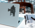 Laptop computer with black decal of Bigfoot relaxing in a chair, holding a beer mug.