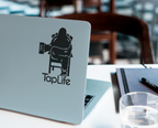 Laptop with black decal of Bigfoot relaxing in a chair, holding a beer mug, with Tap Life logo below.