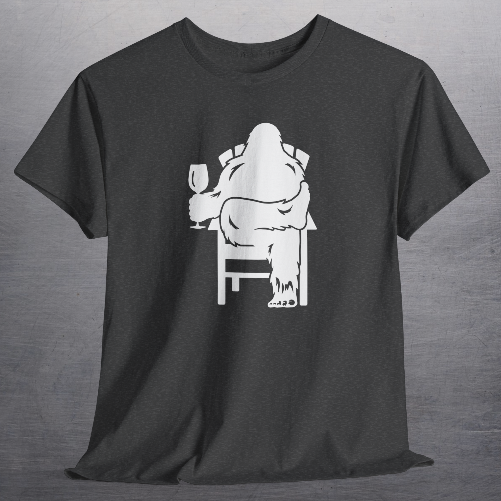 Heather charcoal gray t-shirt with white print of Bigfoot relaxing in a chair and enjoying a glass of wine.