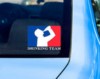 Back window of car with decal sticker of silhouette man drinking beer with red and blue background, like professional sports logo, and words Drinking Team underneath.