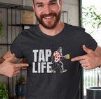 Man wearing a charcoal gray t-shirt with 'Tap Life' text and Bigfoot wearing a Hawaiian shirt and holding a beer