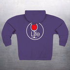 Round "Wine Life" logo with red wine glass on the back of a purple hoodie, on a gray background.