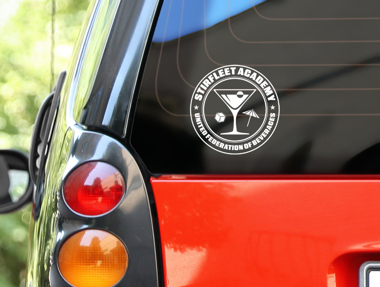 Rear window of car with United Federation of Beverages Stirfleet Academy sticker decal, white graphic design with martini glass, ice cube, and umbrella