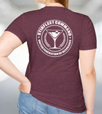 Woman wearing Heather red maroon t-shirt, with white United Federation of Beverages Stirfleet Command logo, martini glass graphic on back of shirt.