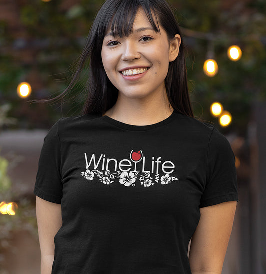 Woman wearing a black Wine Life T-shirt with beautiful hibiscus flowers