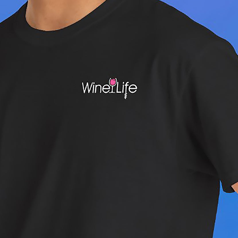 Closeup of man wearing black t-shirt with the Wine Life logo featuring a pink rose' wine glass and corkscrew