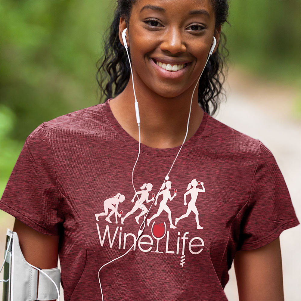 Running Woman Wine Life T-Shirt worn by a smiling woman enjoying her run with a playful graphic design.