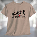 Running Woman Wine Life T-Shirt featuring playful graphic of women running with wine glasses on a soft fabric.