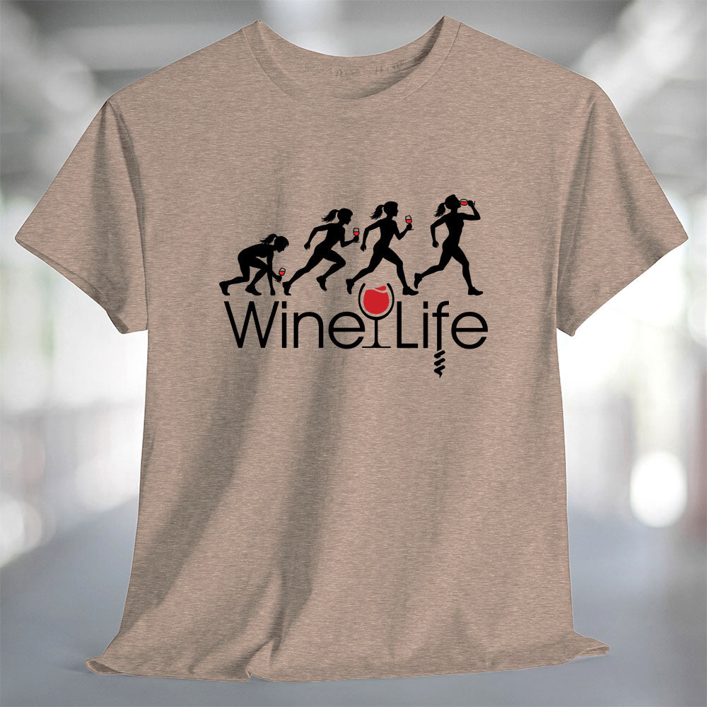 Running Woman Wine Life T-Shirt featuring playful graphic of women running with wine glasses on a soft fabric.