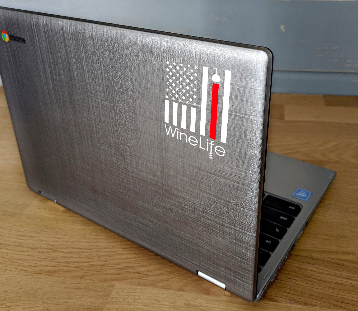 Laptop computer with decal of American flag with one red stripe pouring from a wine glass, Wine Life logo below