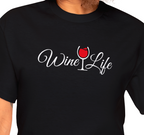 Woman wearing black t-shirt, white Wine Life logo with script styled letters, and wine glass full of red wine.