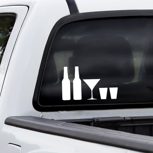 Rear window of a truck with stick family decals of solid white beer bottles, martini glass, and shot glasses