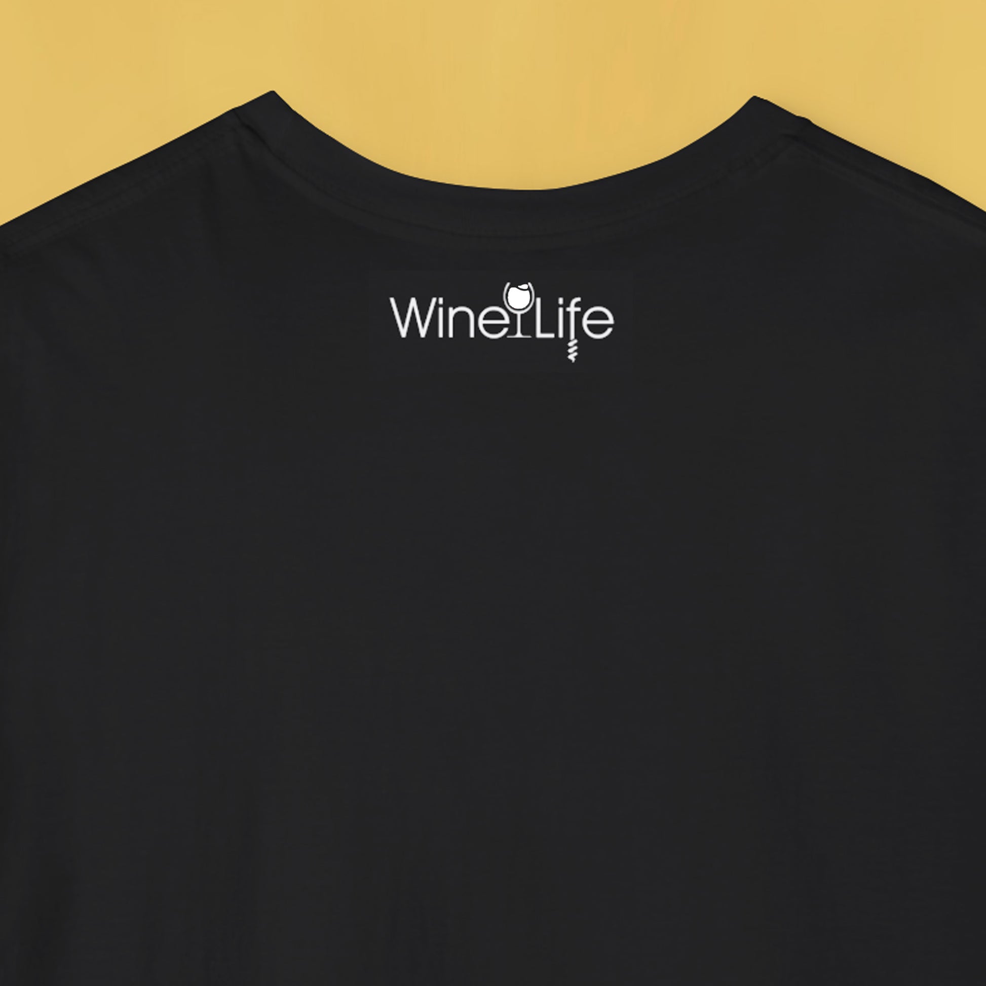 Back neckline of black t-shirt with wine life logo of white wine glass and corkscrew